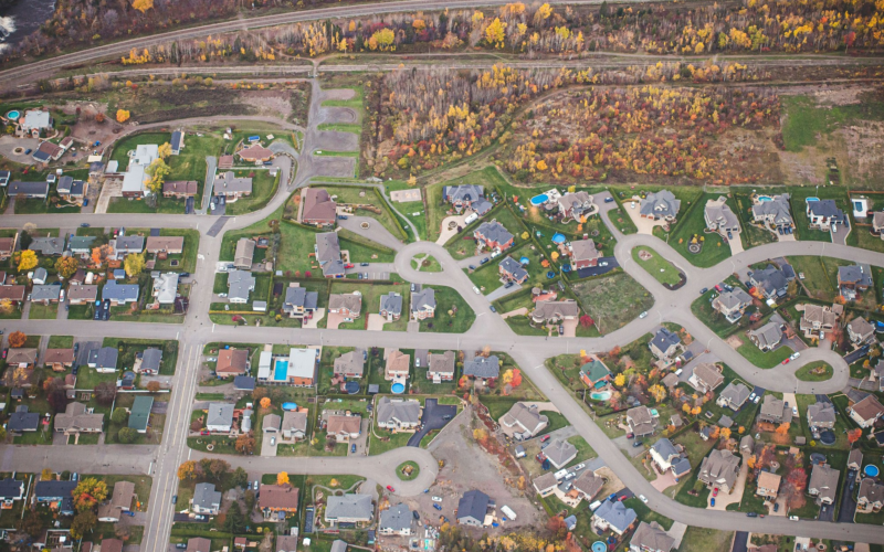 Aerial view of a residential neighborhood with curving streets in autumn