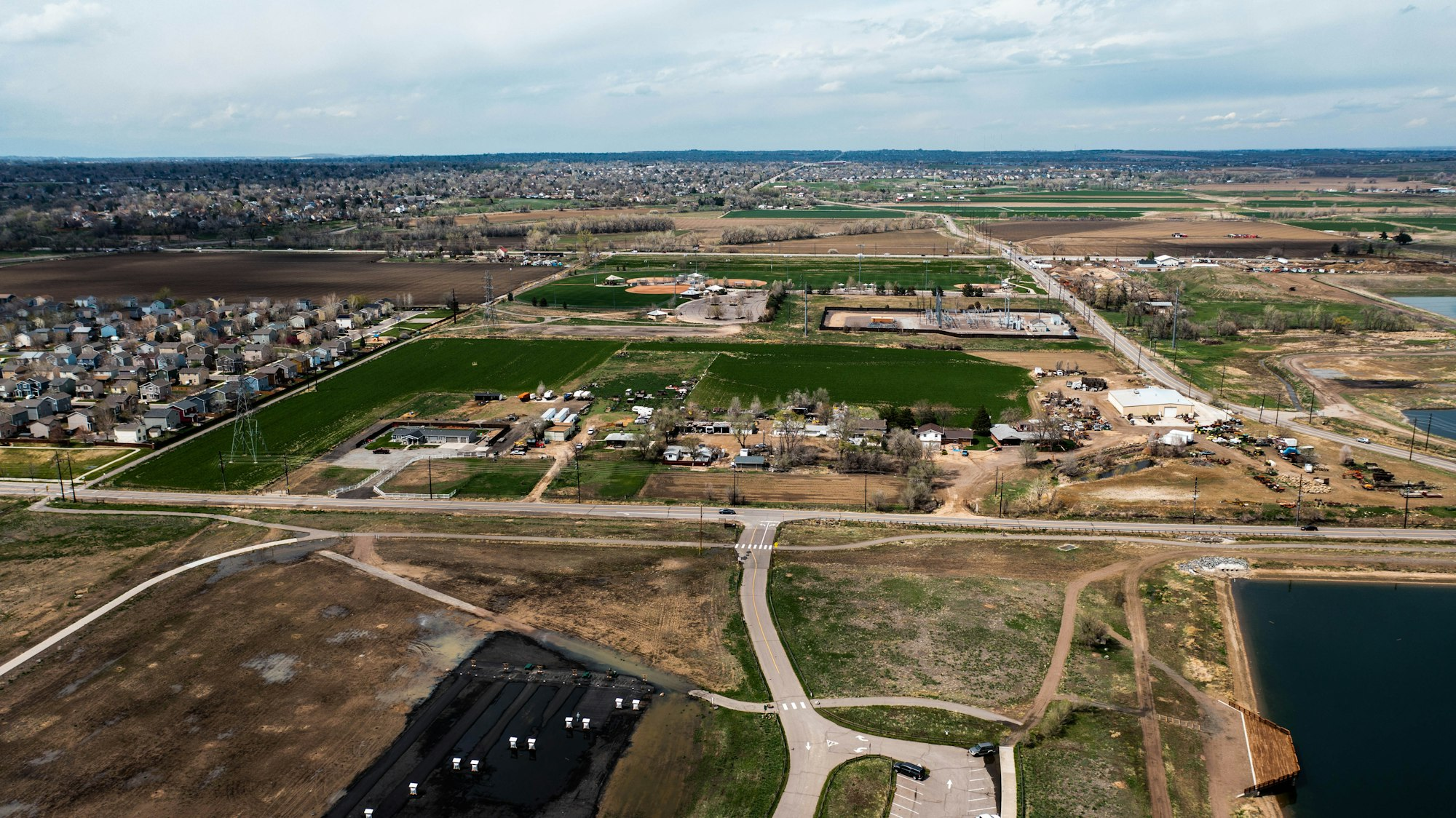 Aerial view of new housing at the edge of farmland